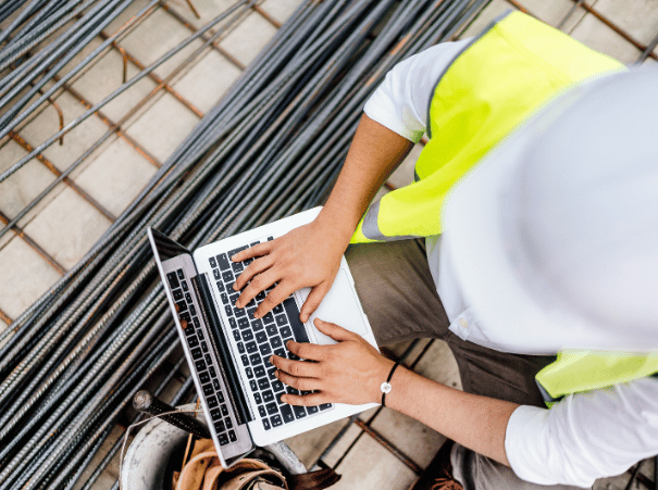 Construction worker on a laptop onsite
