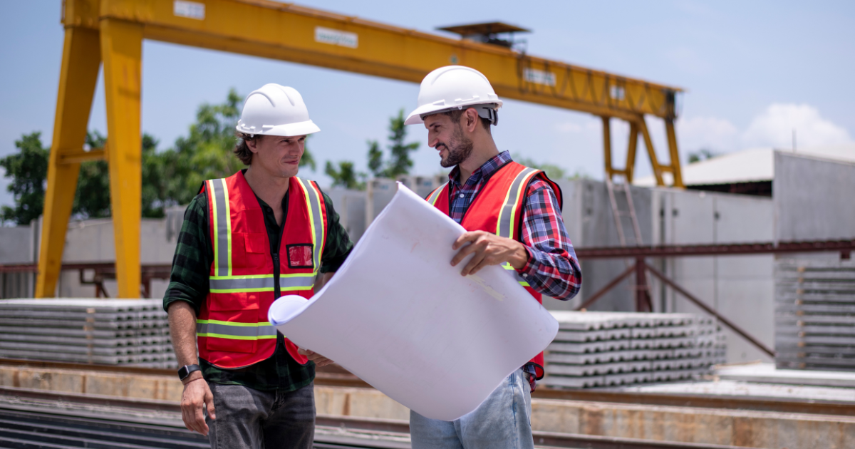 two construction workers on site. two construction workers on site.