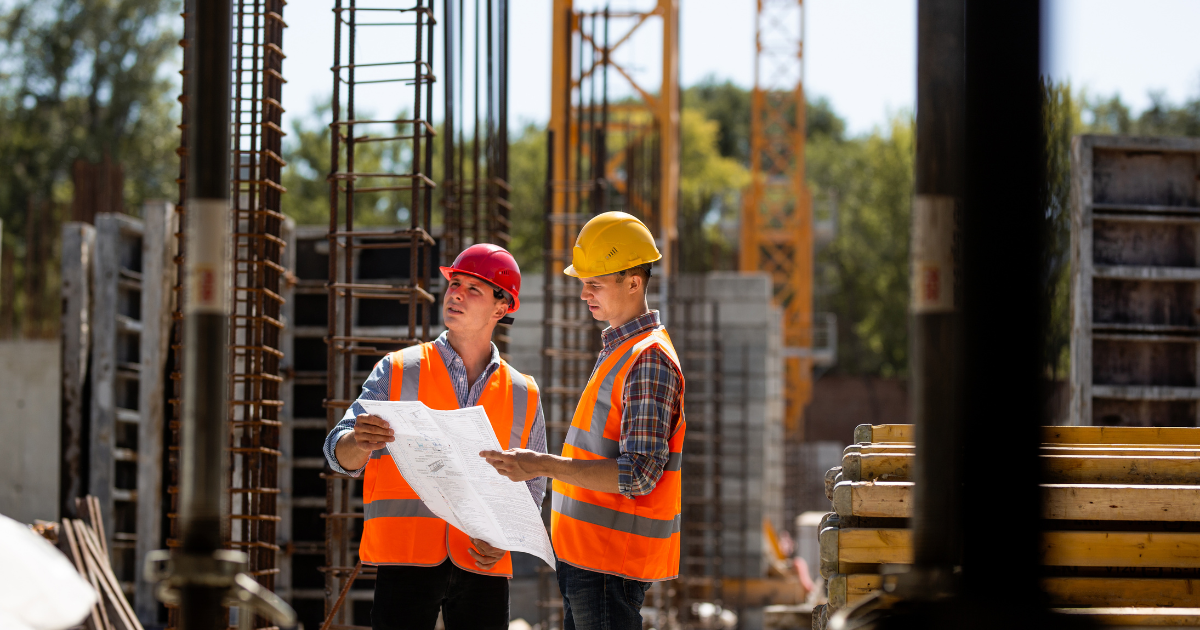 looking over a plan on a building site looking over a plan on a building site