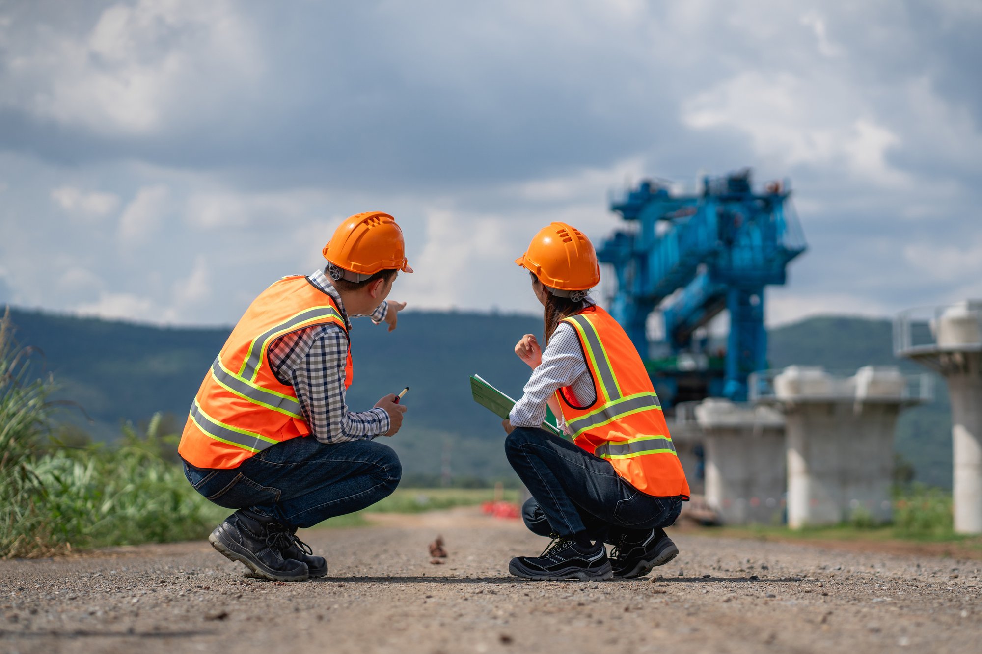Two Construction Workers Surveying a Site