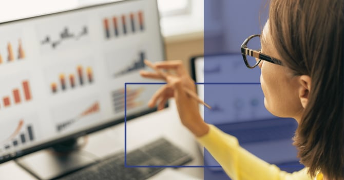 A woman looks at a dashboard on her computer