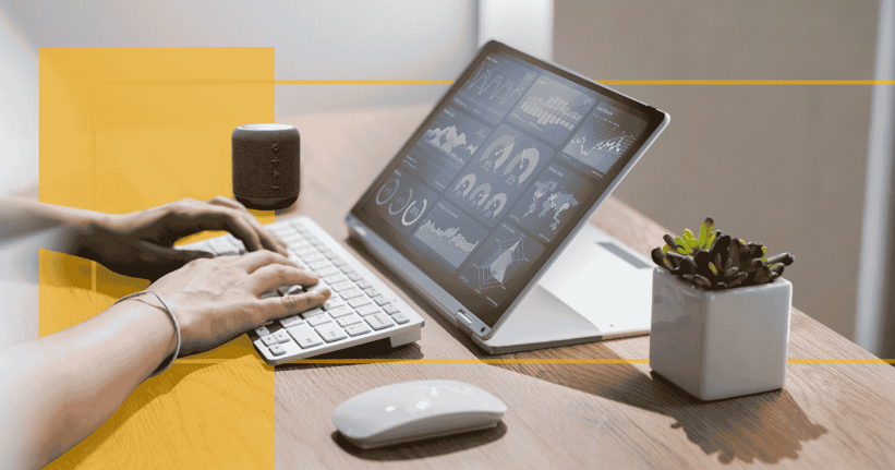 A laptop on desk with a dashboard on the screen
