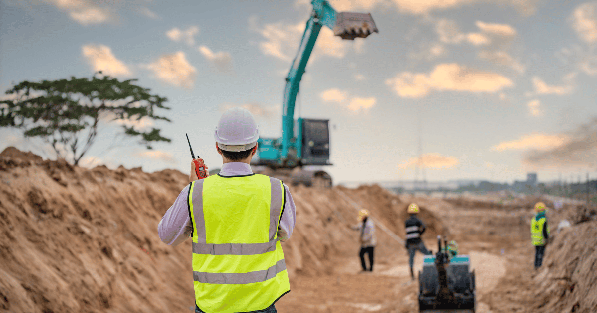 A foreman talks on a walkie on a construction site. A foreman talks on a walkie on a construction site.