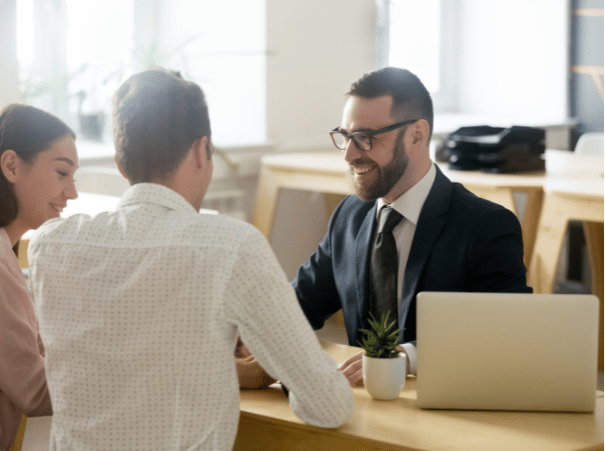 Business man talking with two clients smiling