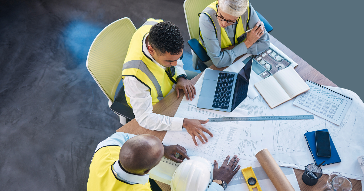 contractors sitting at a table reading paperwork
